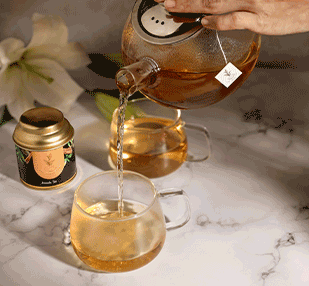 Tea being poured in a cup and a Pekoe tea container