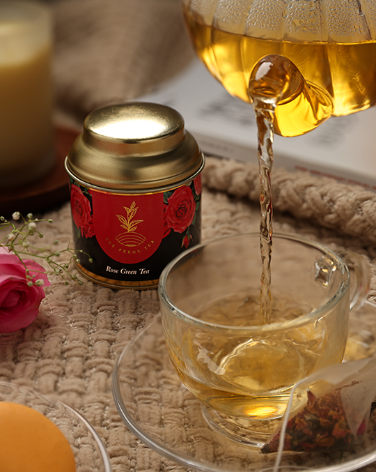 Pekoe Rose Tea in a container and being poured in a glass cup